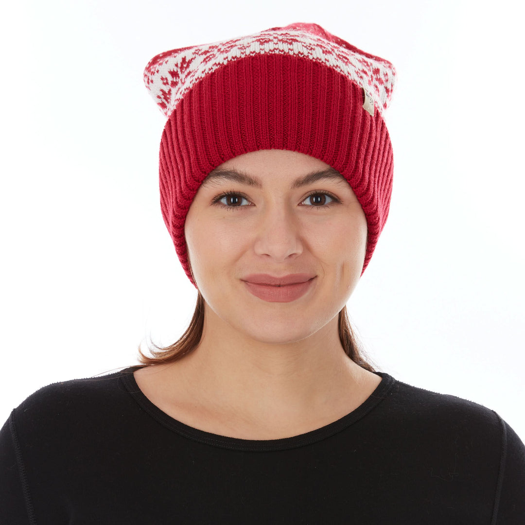 A woman models the midweight, double-layered, hundred percent, super soft merino wool beanie that keeps you warm, but won&