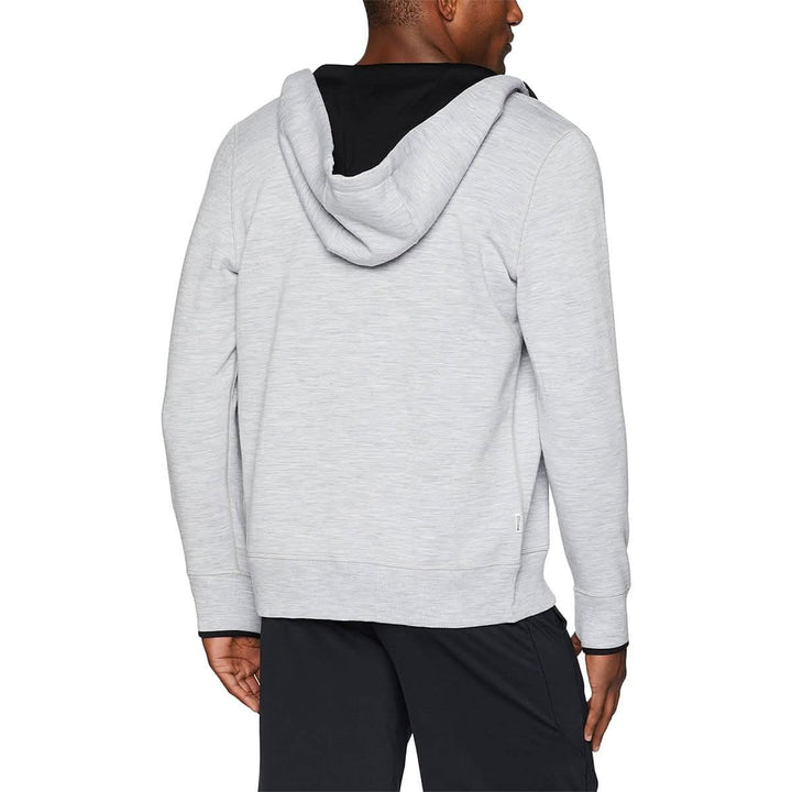 A man models the heavyweight brushed wool Kodiak Fleece Hoodie, crafted with thumbholes and a drawstring to bundle you up for wicked cold days! 