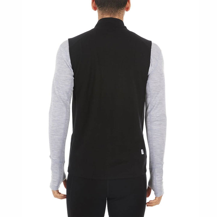 A man models the heavyweight merino wool full-zip vest, back view 