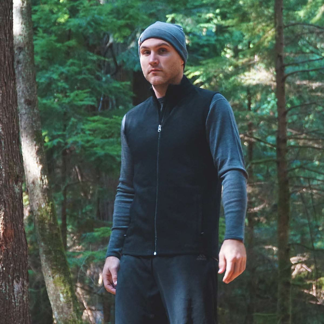 A man models the heavyweight merino wool full-zip vest 