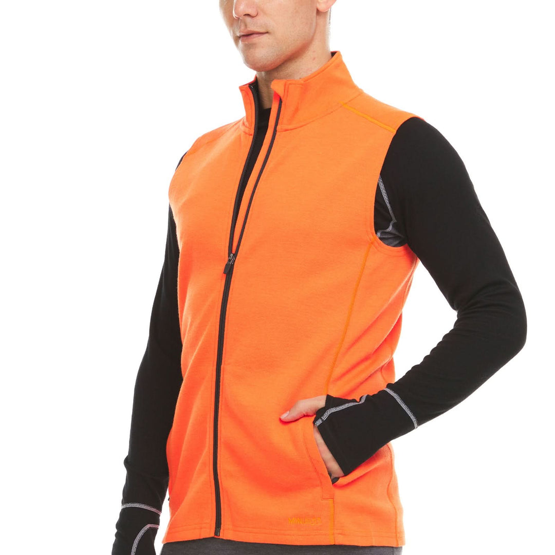 A man models the heavyweight merino wool full-zip vest, front three-quarter view 
