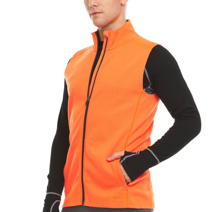 A man models the heavyweight merino wool full-zip vest, front three-quarter view 