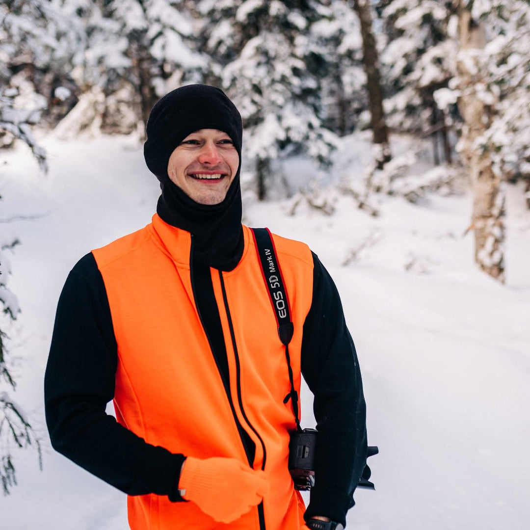 A man models the heavyweight merino wool full-zip vest 