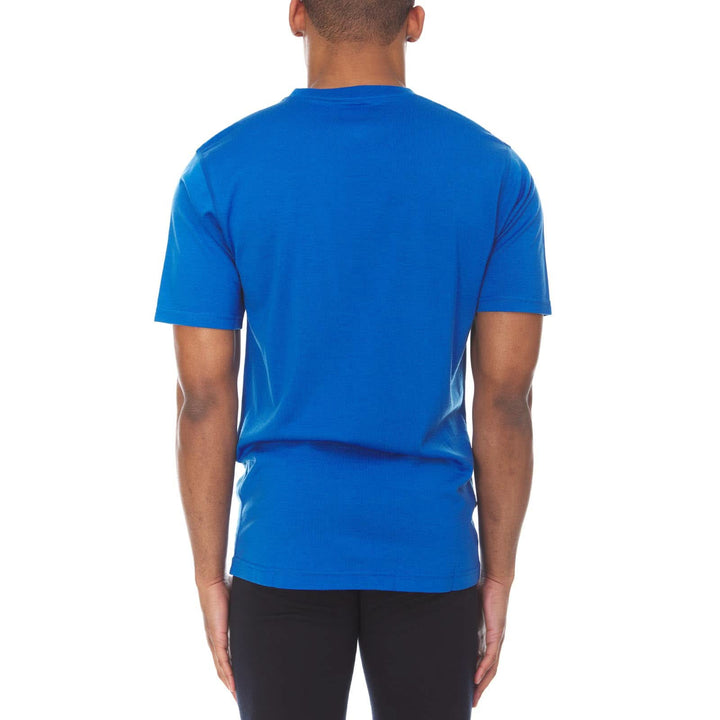 A man models a super soft, short sleeved merino wool t shirt. Use it as a base layer under your work shirt, or wear it all by itself during your next summer summit. 
