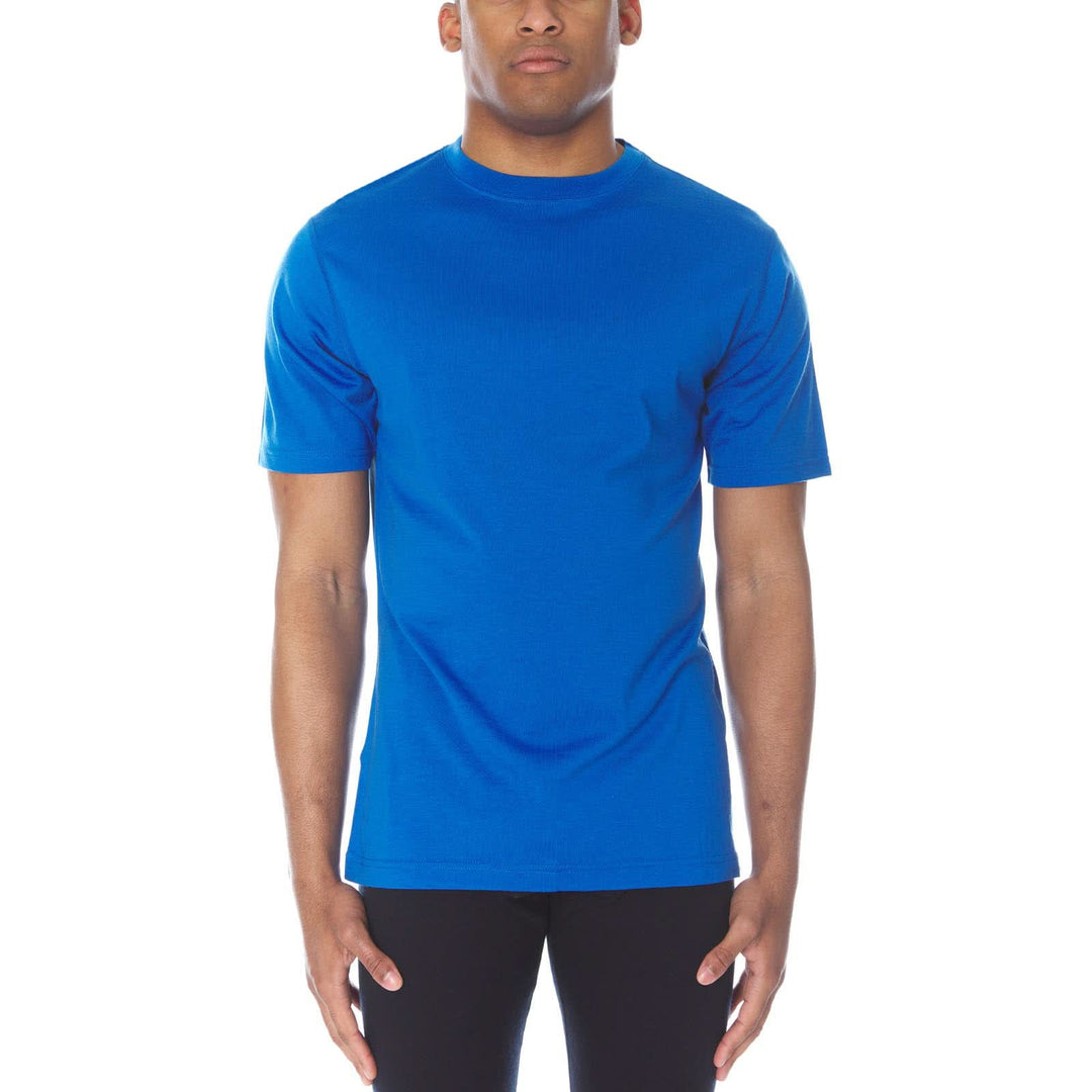 A man models a super soft, short sleeved merino wool t shirt. Use it as a base layer under your work shirt, or wear it all by itself during your next summer summit, front view 