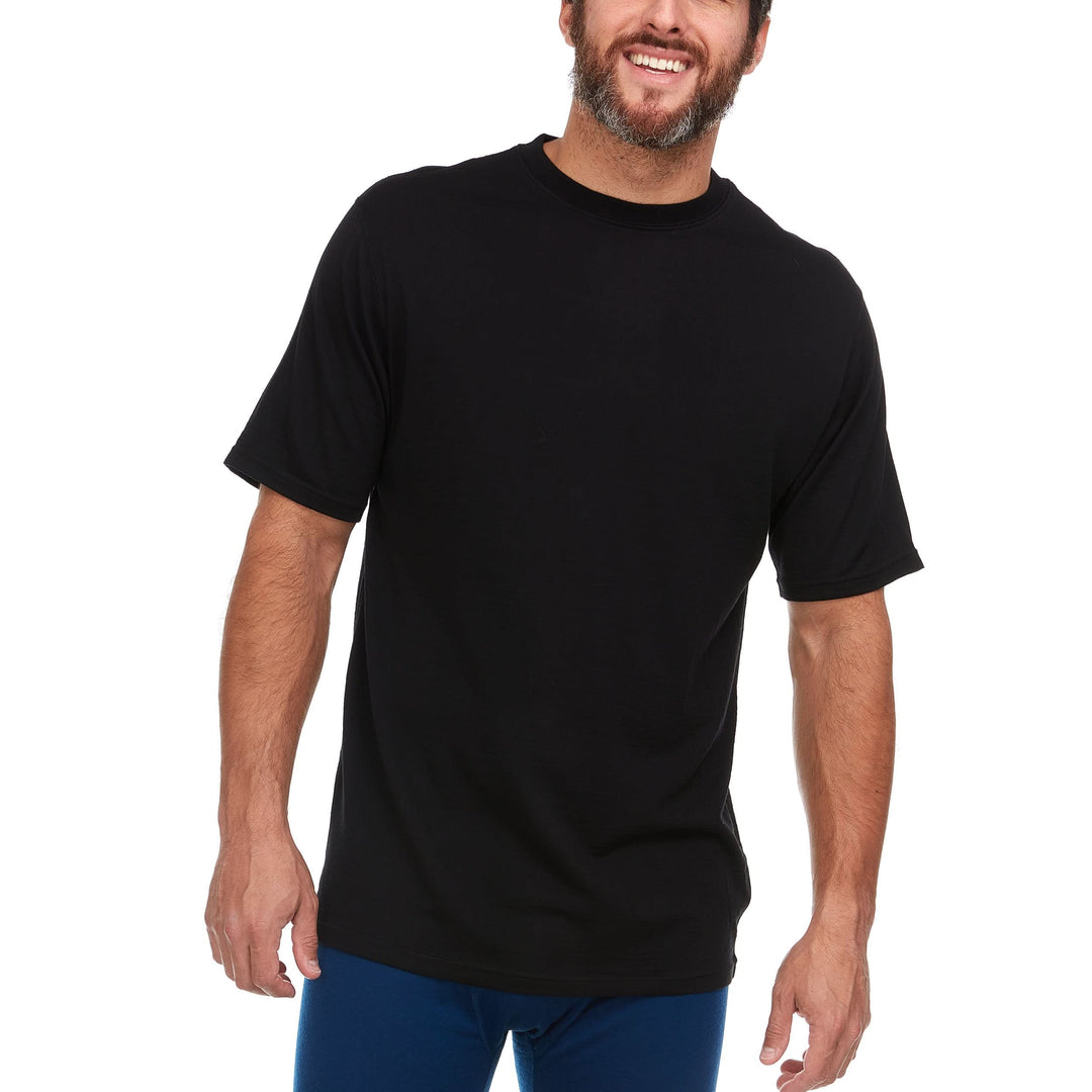 A man models a super soft, short sleeved merino wool t shirt. Use it as a base layer under your work shirt, or wear it all by itself during your next summer summit. 