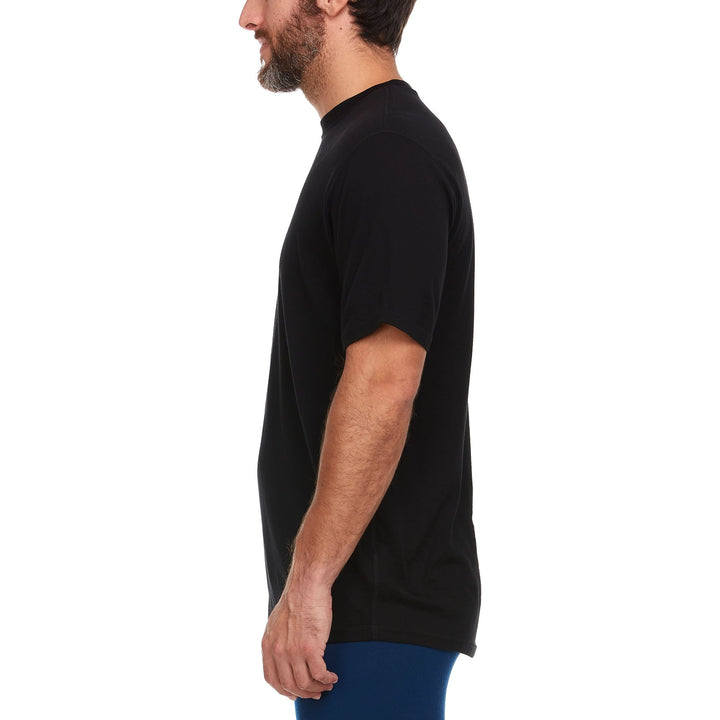 A man models a super soft, short sleeved merino wool merino wool t shirt. Use it as a base layer under your work shirt, or wear it all by itself during your next summer summit. 