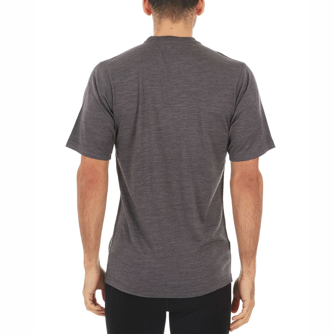 A man models a super soft, short sleeved merino wool t shirt. Use it as a base layer under your work shirt, or wear it all by itself during your next summer summit, back view 