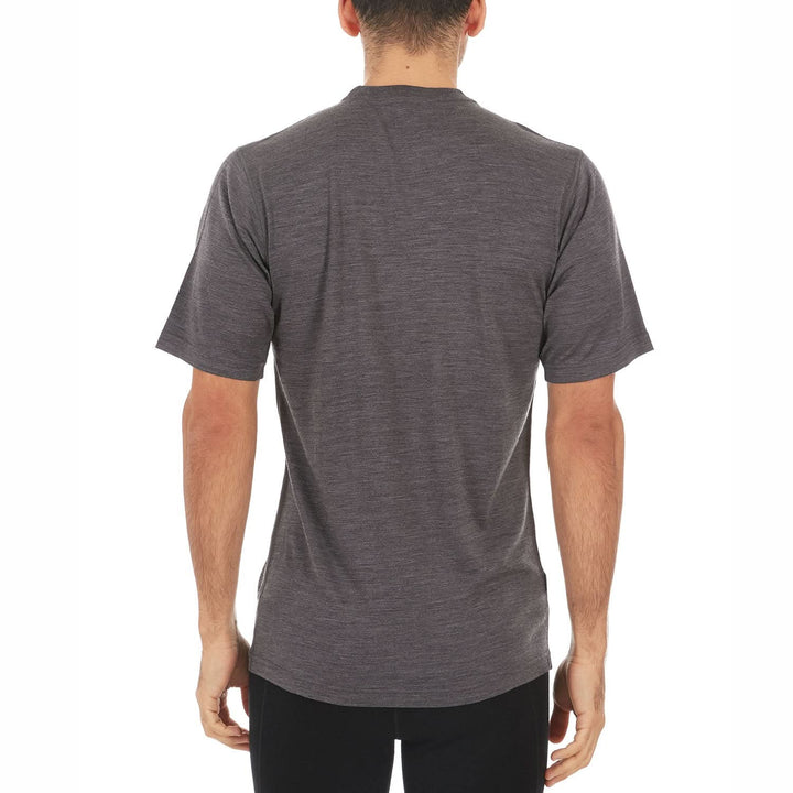 A man models a super soft, short sleeved merino wool t shirt. Use it as a base layer under your work shirt, or wear it all by itself during your next summer summit, back view 