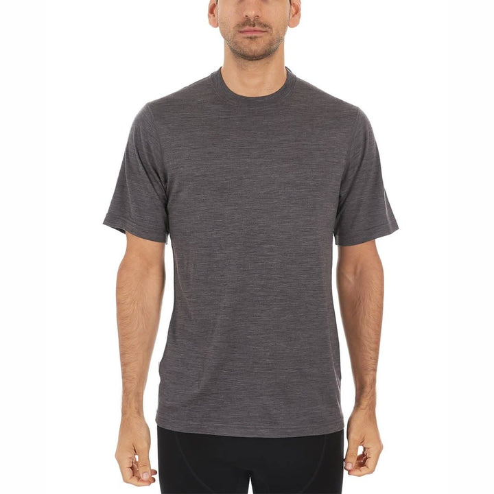 A man models a super soft, short sleeved merino wool t shirt. Use it as a base layer under your work shirt, or wear it all by itself during your next summer summit. 