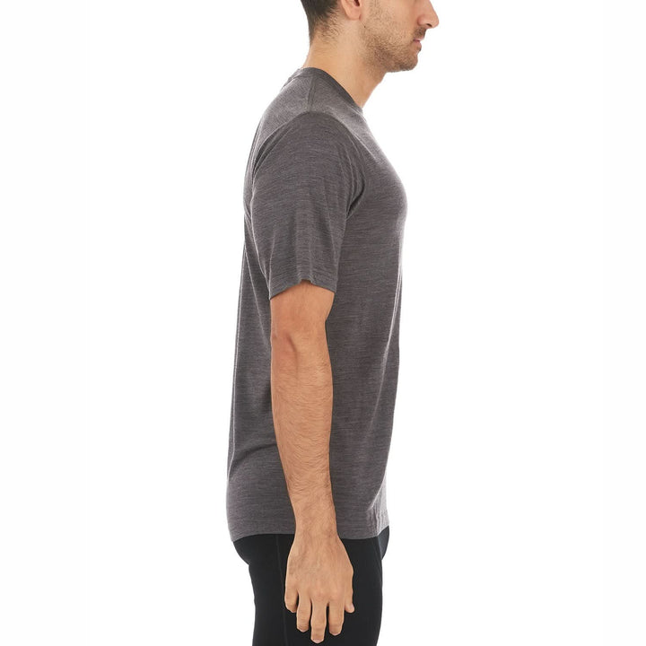 A man models a super soft, short sleeved merino wool t shirt. Use it as a base layer under your work shirt, or wear it all by itself during your next summer summit, right-facing side view 