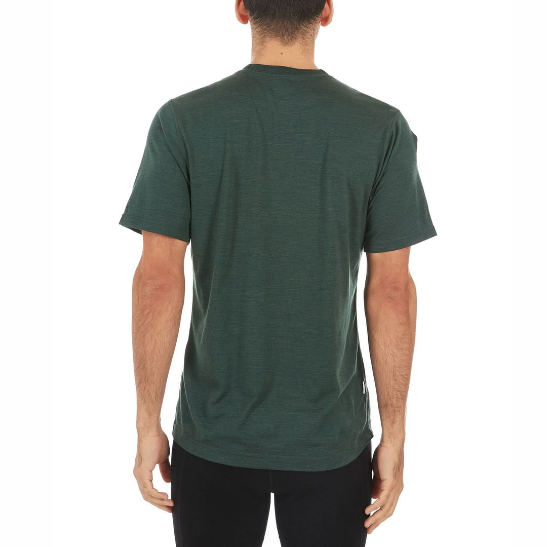 A man models a super soft, short sleeved merino wool t shirt. Use it as a base layer under your work shirt, or wear it all by itself during your next summer summit. 