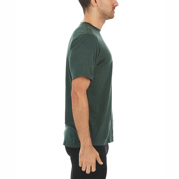 A man models a super soft, short sleeved merino wool t shirt. Use it as a base layer under your work shirt, or wear it all by itself during your next summer summit, right-facing side view 
