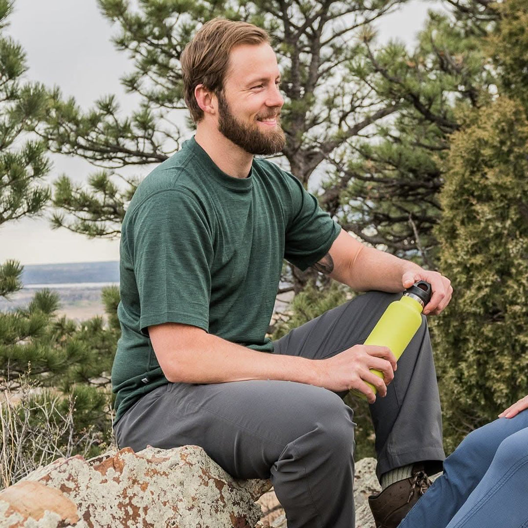 A man models a super soft, short sleeved merino wool t shirt. Use it as a base layer under your work shirt, or wear it all by itself during your next summer summit, front three-quarter view 