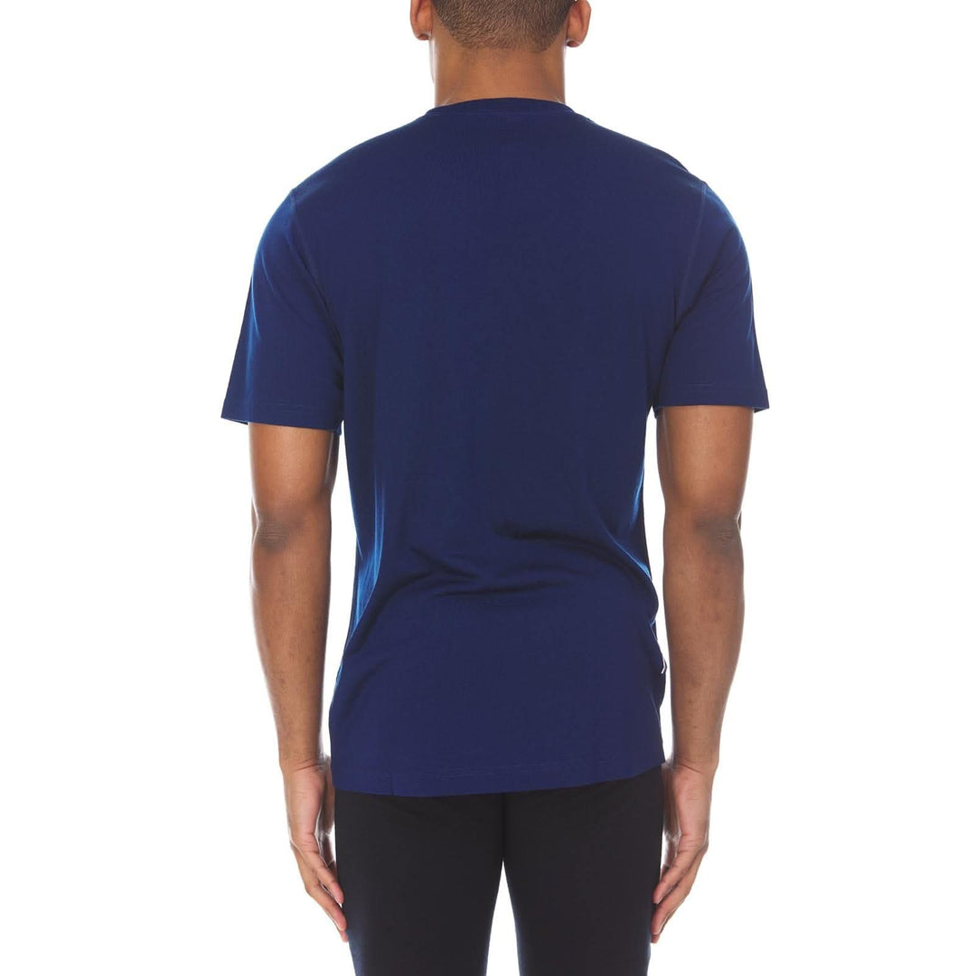 A man models a super soft, short sleeved merino wool t shirt. Use it as a base layer under your work shirt, or wear it all by itself during your next summer summit. 