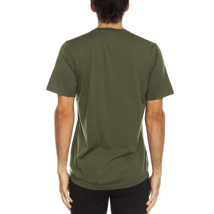A man models a super soft, short sleeved merino wool t shirt. Use it as a base layer under your work shirt, or wear it all by itself during your next summer summit. 