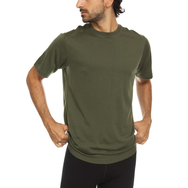 A man models a super soft, short sleeved merino wool t shirt. Use it as a base layer under your work shirt, or wear it all by itself during your next summer summit, front three-quarter view 
