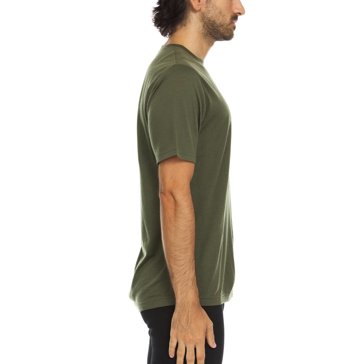 A man models a super soft, short sleeved merino wool t shirt. Use it as a base layer under your work shirt, or wear it all by itself during your next summer summit, right-facing side view 