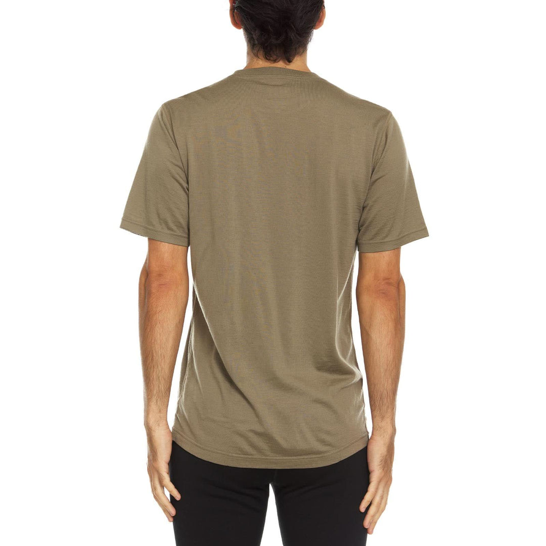 A man models a super soft, short sleeved merino wool t shirt. Use it as a base layer under your work shirt, or wear it all by itself during your next summer summit, back view 