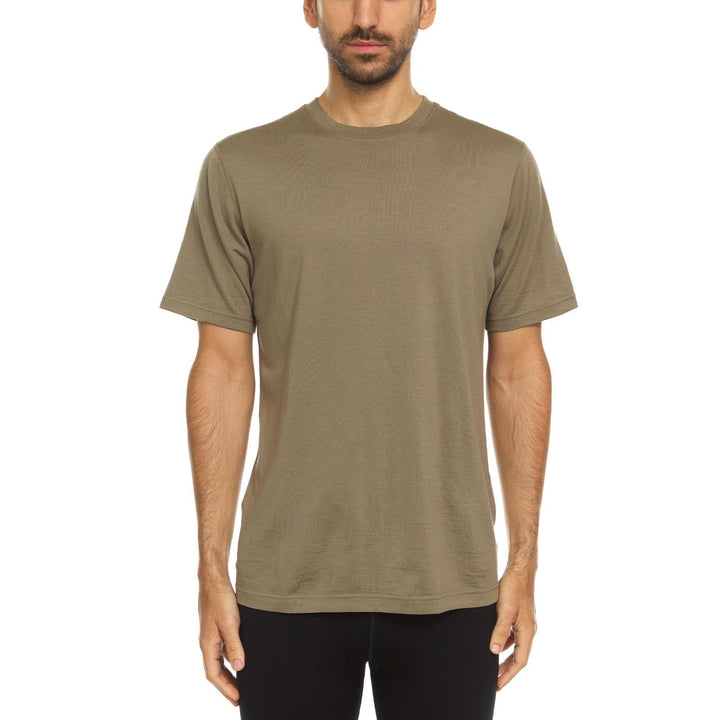 A man models a super soft, short sleeved merino wool t shirt. Use it as a base layer under your work shirt, or wear it all by itself during your next summer summit, front view 