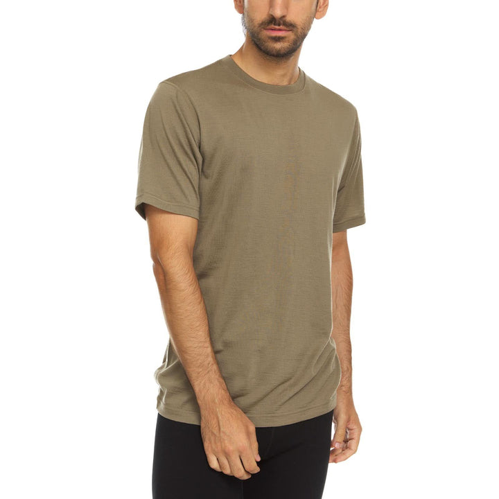 A man models a super soft, short sleeved merino wool t shirt. Use it as a base layer under your work shirt, or wear it all by itself during your next summer summit. 