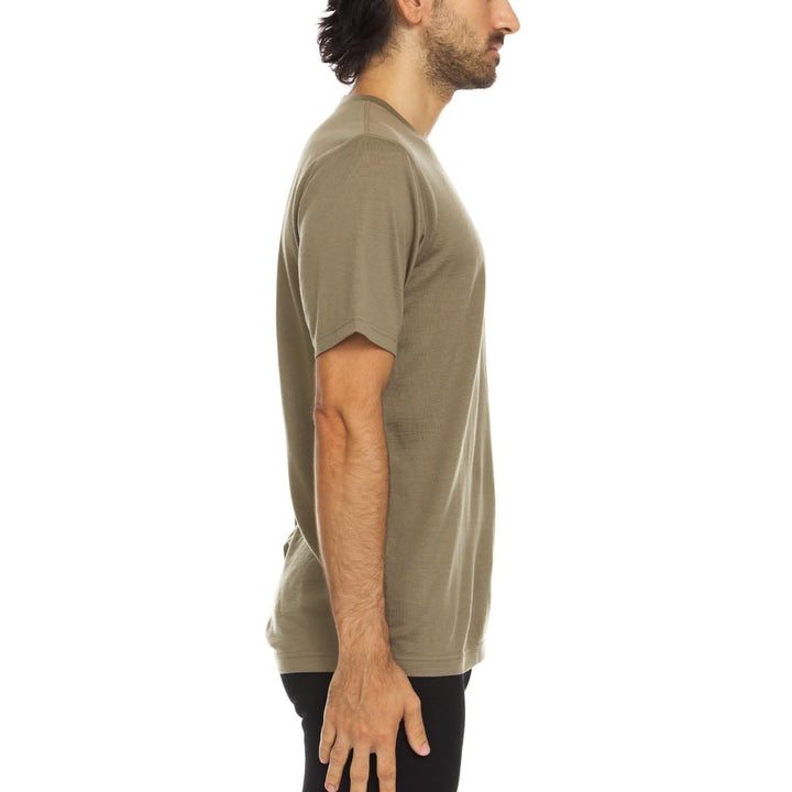 A man models a super soft, short sleeved merino wool t shirt. Use it as a base layer under your work shirt, or wear it all by itself during your next summer summit, right-facing side view 