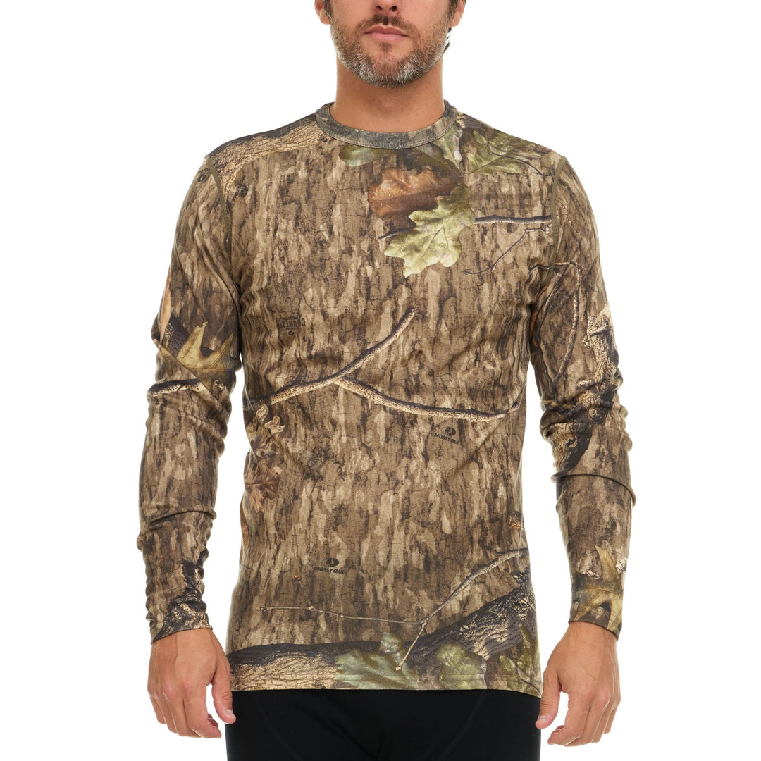 A man models a super soft, long sleeved merino wool thermal base layer crew. This top makes for a perfect first layer on a winter hike, or a nice casual wear on the chilly days of autumn and spring. 