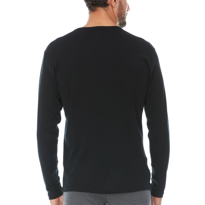 A man models a super soft, long sleeved merino wool thermal base layer crew. This top makes for a perfect first layer on a winter hike, or a nice casual wear on the chilly days of autumn and spring. 