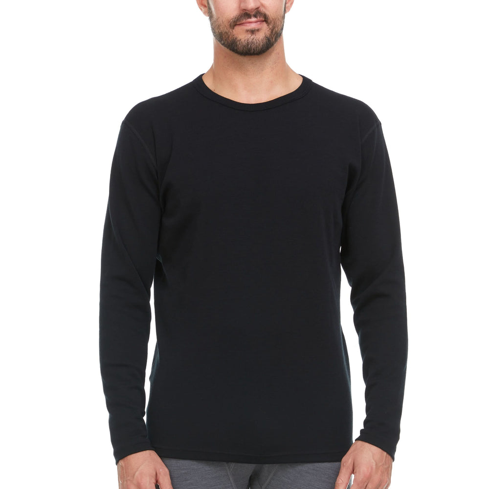 A man models a super soft, long sleeved merino wool thermal base layer crew. This top makes for a perfect first layer on a winter hike, or a nice casual wear on the chilly days of autumn and spring. #color_black