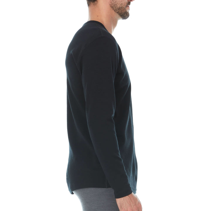 Side view of a black midweight merino wool base-layer crew top