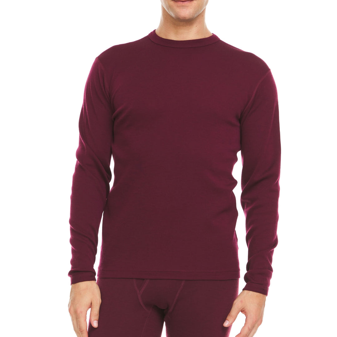 A man models a super soft, long sleeved merino wool thermal base layer crew. This top makes for a perfect first layer on a winter hike, or a nice casual wear on the chilly days of autumn and spring. 