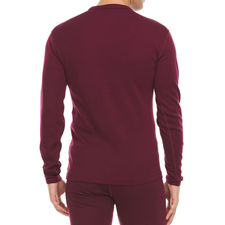 A man models a super soft, long sleeved merino wool thermal base layer crew. This top makes for a perfect first layer on a winter hike, or a nice casual wear on the chilly days of autumn and spring, back view 
