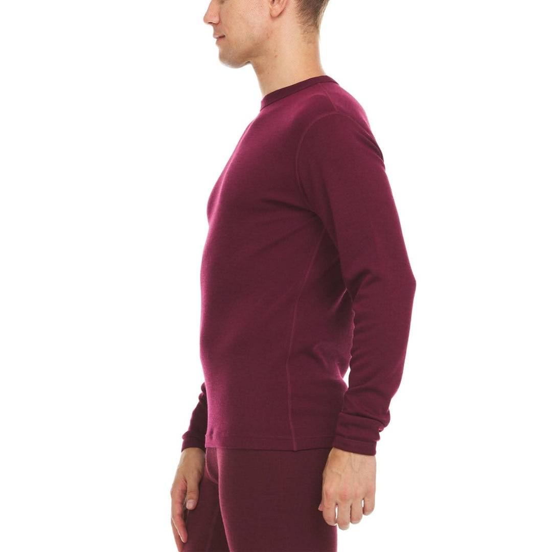 A man models a super soft, long sleeved merino wool thermal base layer crew. This top makes for a perfect first layer on a winter hike, or a nice casual wear on the chilly days of autumn and spring, right-facing side view 