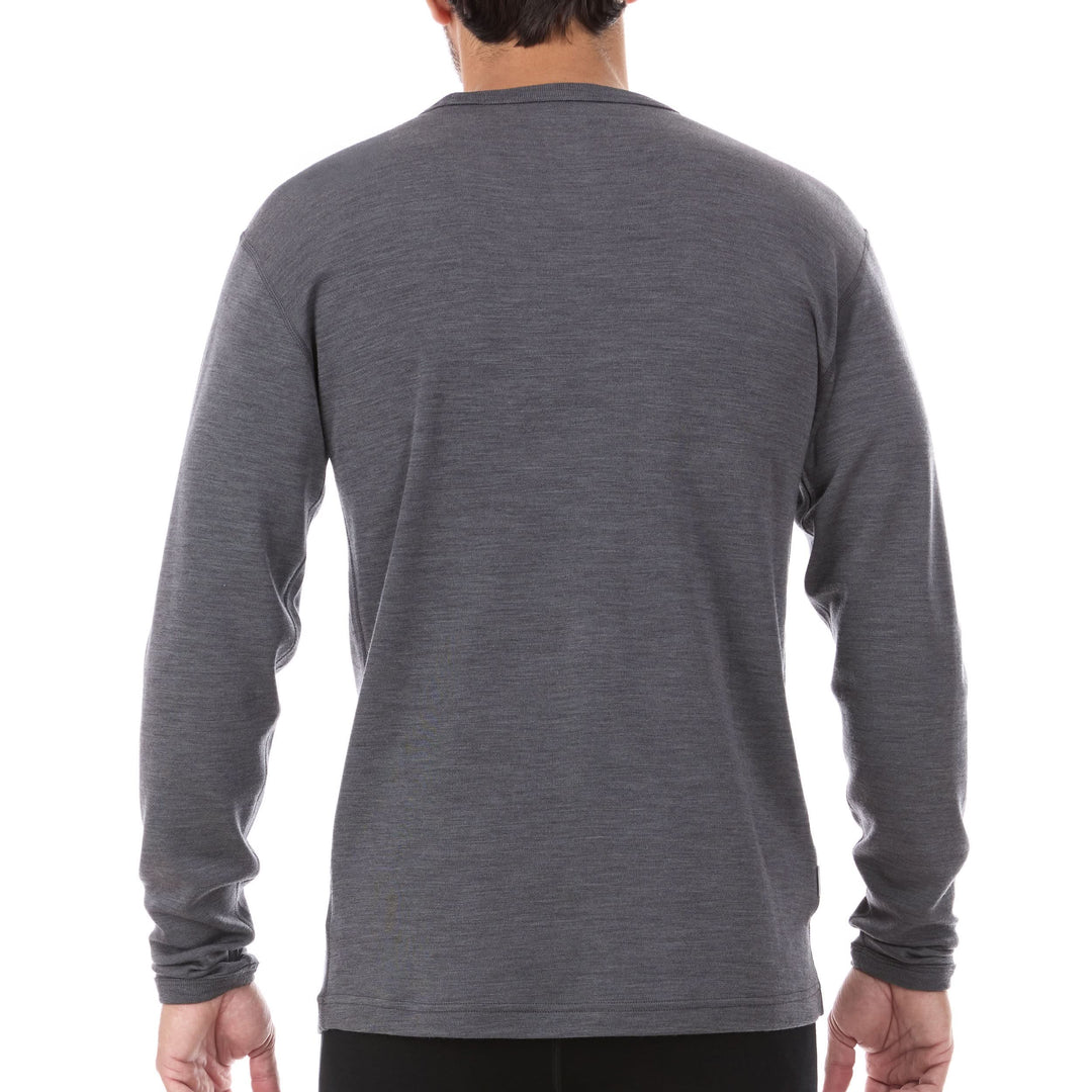 A man models a super soft, long sleeved merino wool thermal base layer crew. This top makes for a perfect first layer on a winter hike, or a nice casual wear on the chilly days of autumn and spring. 
