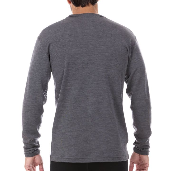 A man models a super soft, long sleeved merino wool thermal base layer crew. This top makes for a perfect first layer on a winter hike, or a nice casual wear on the chilly days of autumn and spring. 
