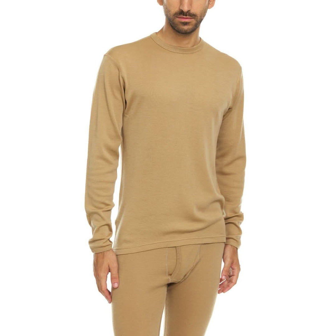 A man models a super soft, long sleeved merino wool thermal base layer crew. This top makes for a perfect first layer on a winter hike, or a nice casual wear on the chilly days of autumn and spring. 