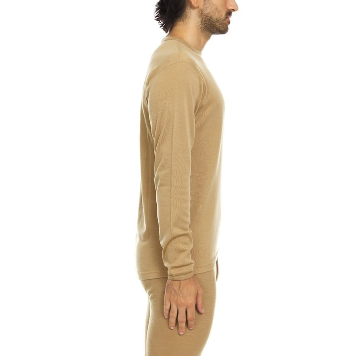 A man models a super soft, long sleeved merino wool thermal base layer crew. This top makes for a perfect first layer on a winter hike, or a nice casual wear on the chilly days of autumn and spring, right-facing side view 
