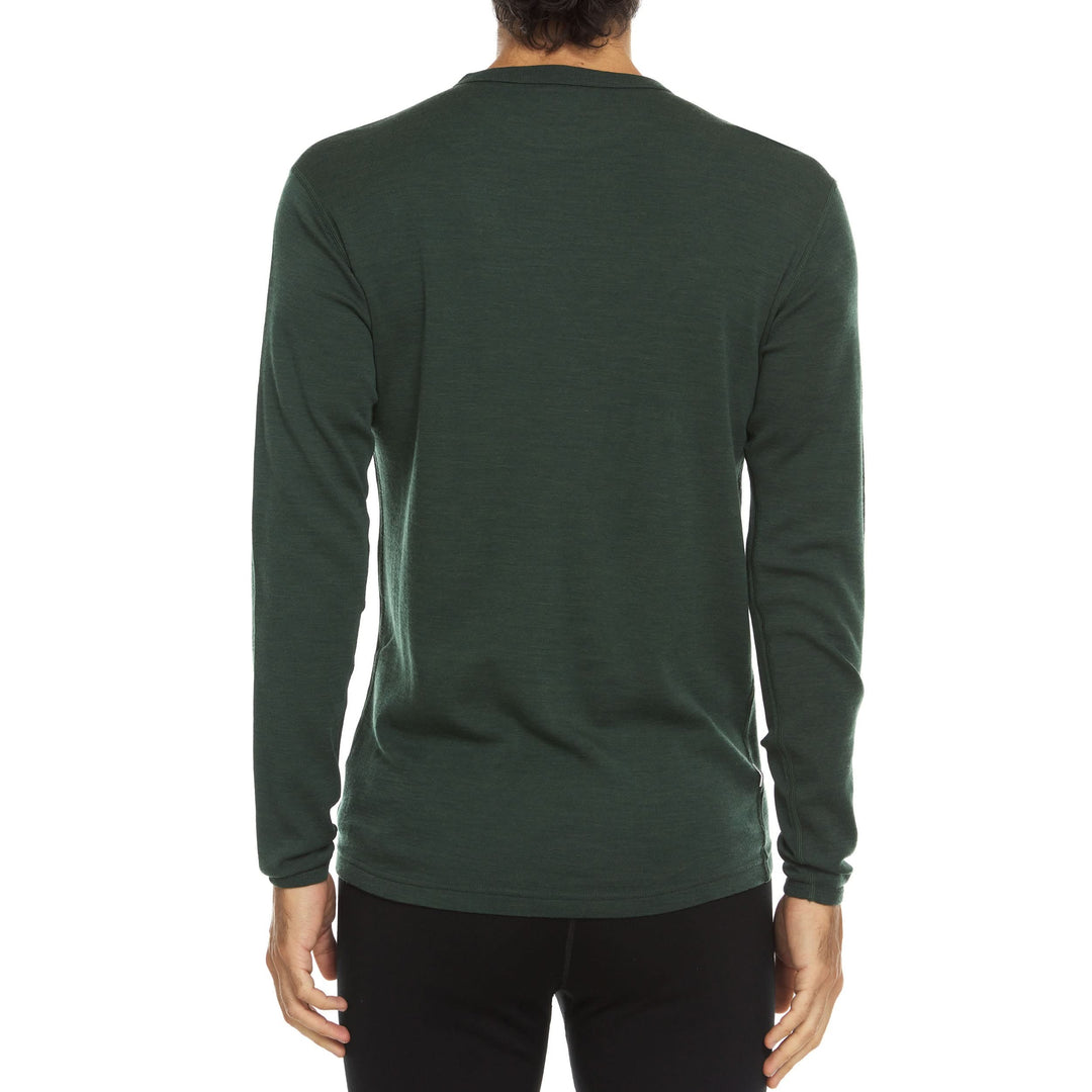 A man models a super soft, long sleeved merino wool thermal base layer crew. This top makes for a perfect first layer on a winter hike, or a nice casual wear on the chilly days of autumn and spring. 