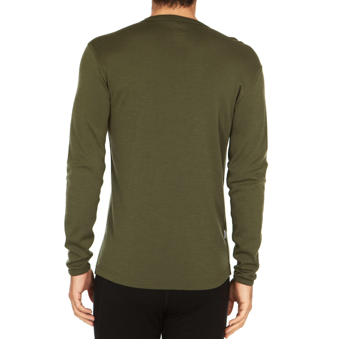 A man models a super soft, long sleeved merino wool thermal base layer crew. This top makes for a perfect first layer on a winter hike, or a nice casual wear on the chilly days of autumn and spring, back view 