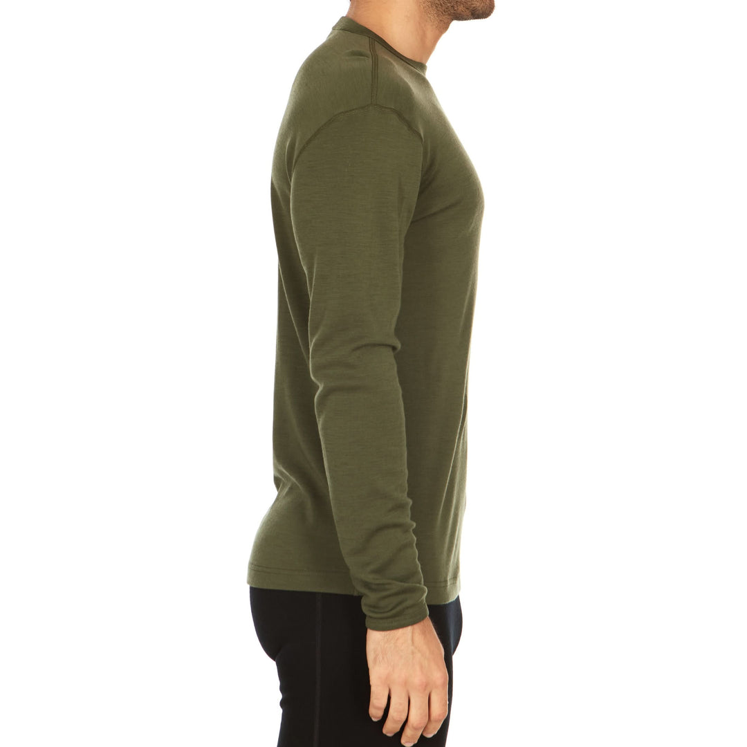 A man models a super soft, long sleeved merino wool thermal base layer crew. This top makes for a perfect first layer on a winter hike, or a nice casual wear on the chilly days of autumn and spring, right-facing side view 