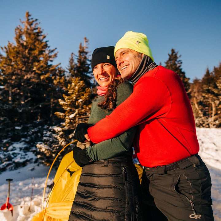 A man models a super soft, long sleeved merino wool thermal base layer crew. This top makes for a perfect first layer on a winter hike, or a nice casual wear on the chilly days of autumn and spring, front view on a hiking trail 