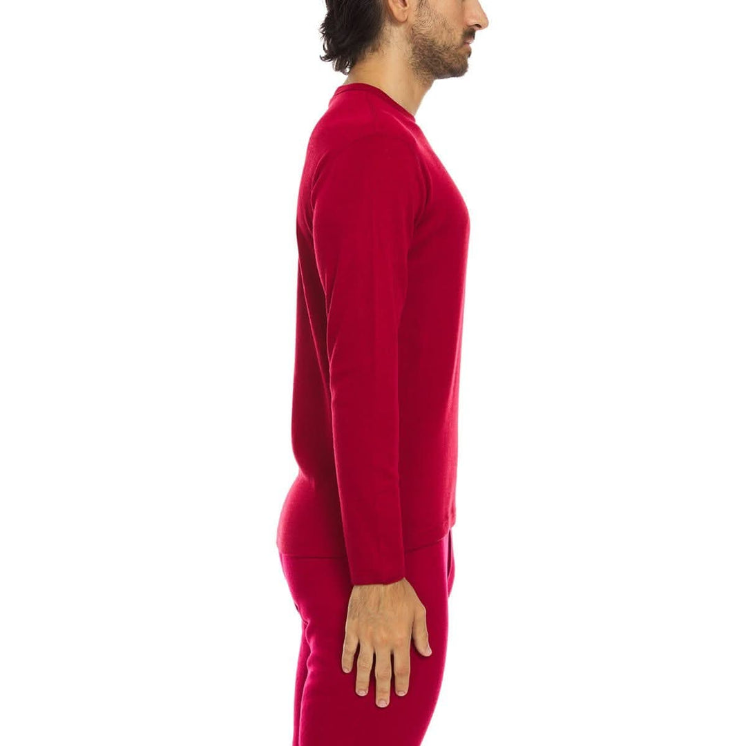 A man models a super soft, long sleeved merino wool thermal base layer crew. This top makes for a perfect first layer on a winter hike, or a nice casual wear on the chilly days of autumn and spring, right-facing side view 