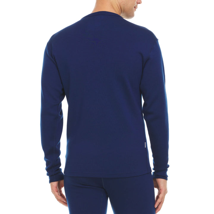 A man models a super soft, long sleeved merino wool thermal base layer crew. Whether you&