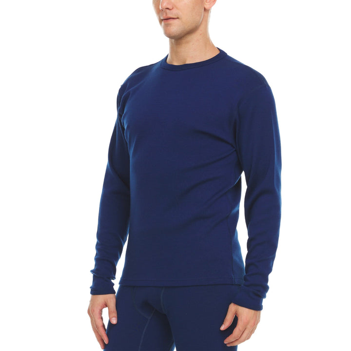 A man models a super soft, long sleeved merino wool thermal base layer crew. Whether you&