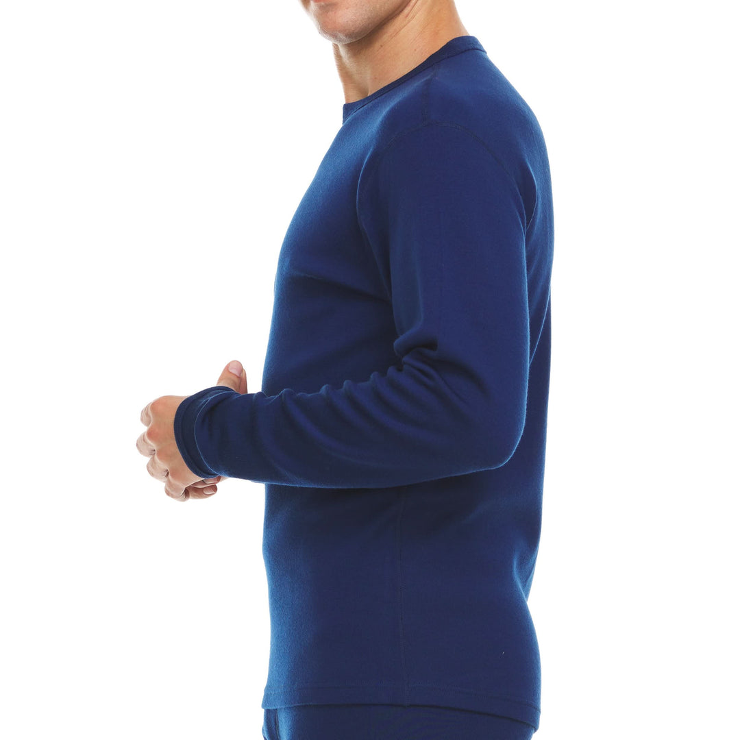A man models a super soft, long sleeved merino wool thermal base layer crew. Whether you&
