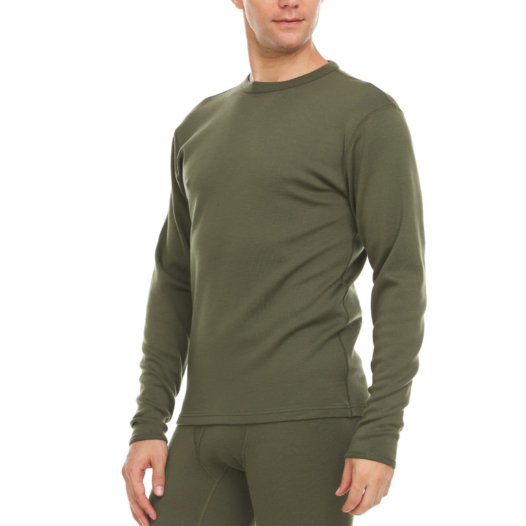 A man models a super soft, long sleeved merino wool thermal base layer crew. Whether you&