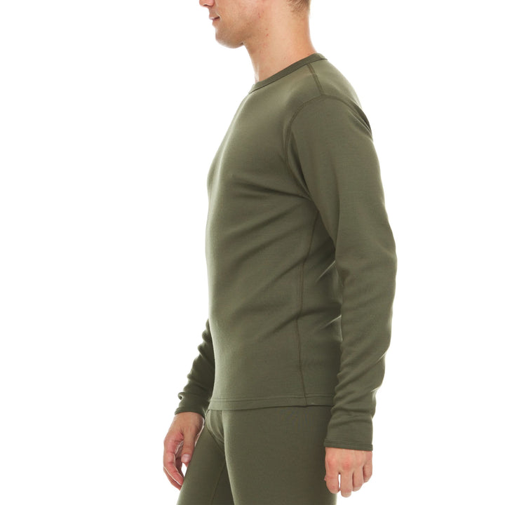 A man models a super soft, long sleeved merino wool thermal base layer crew. Whether you&
