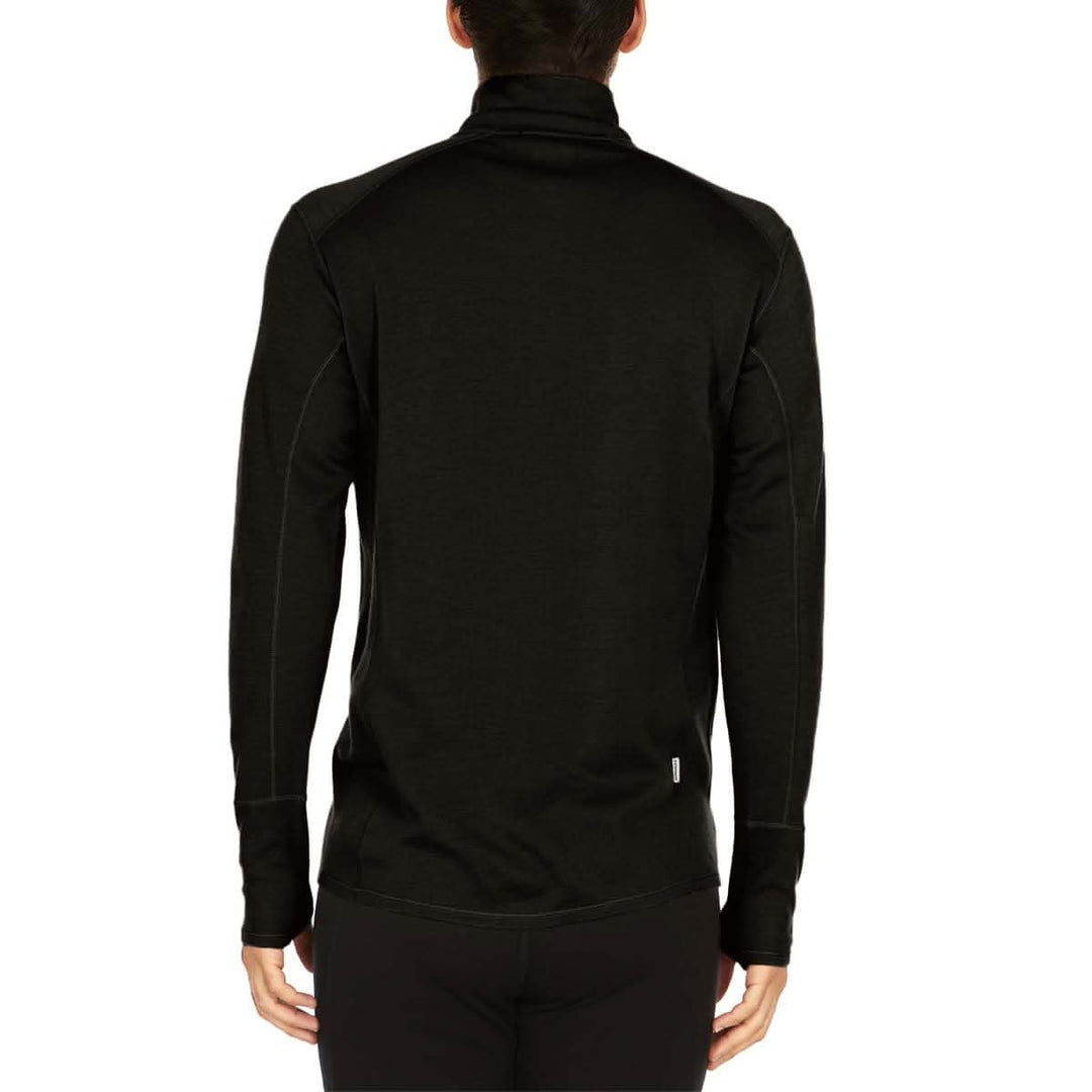 A man models the merino wool midweight quarter zip sweater, complete with flat-lock seams and thumbholes. 