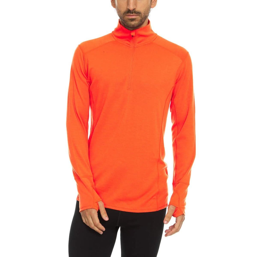 A man models the merino wool midweight quarter zip sweater, complete with flat-lock seams and thumbholes. 