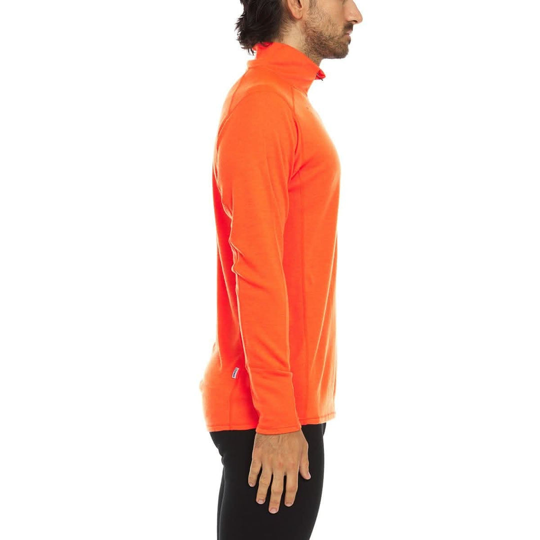 A man models the merino wool midweight quarter zip sweater, complete with flat-lock seams and thumbholes, right-facing side view 